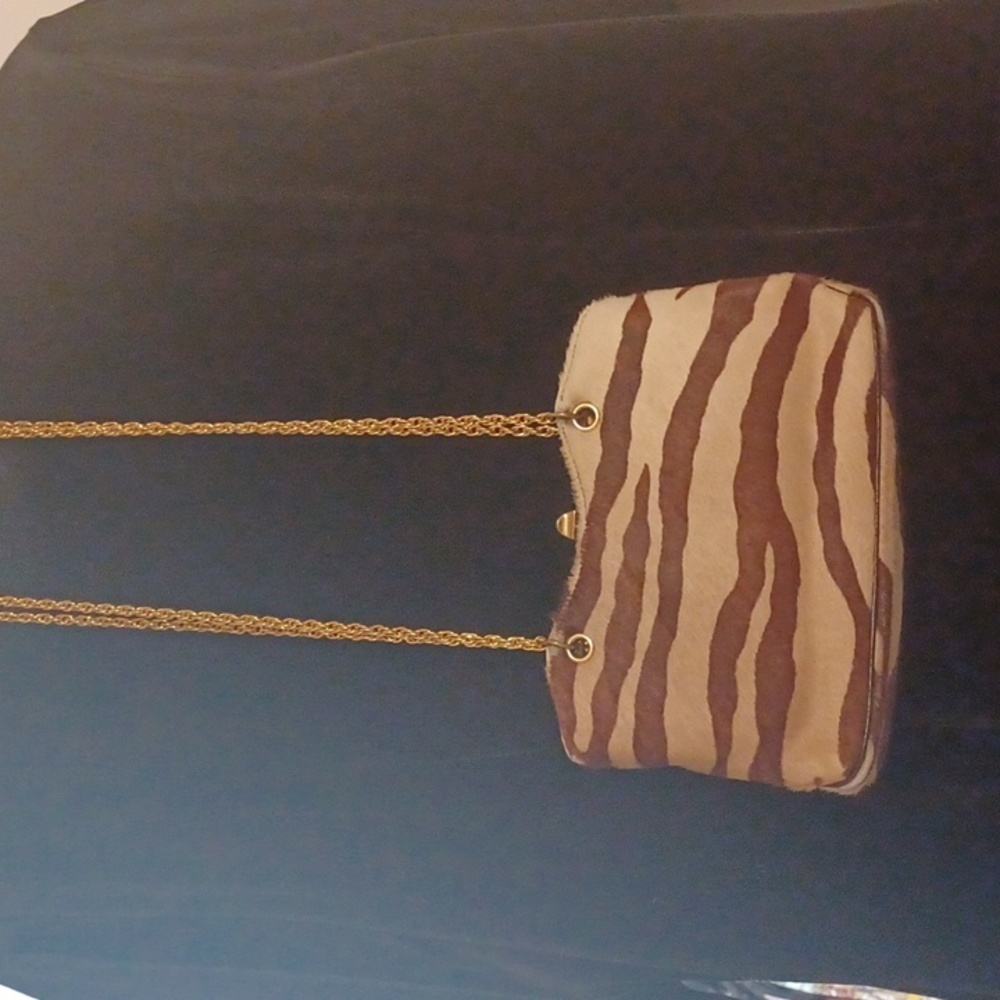 Cow print and texture handbag. Brow and cream color. A little worn on the bottom